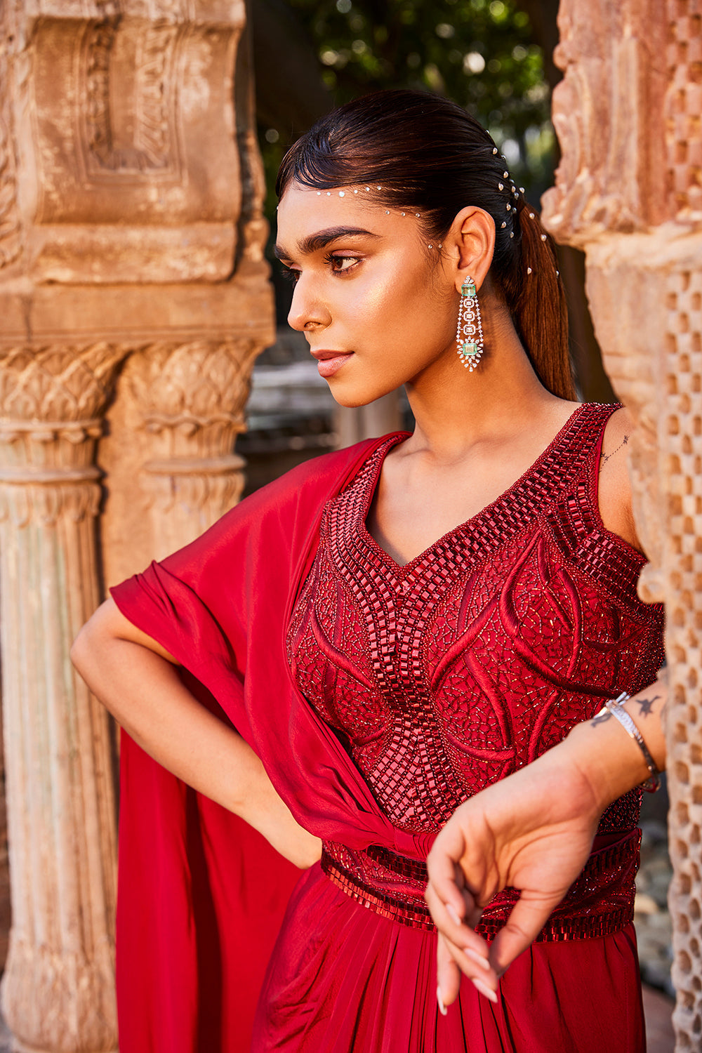 Red Gown With Sari Drape And An Embroidered Belt.